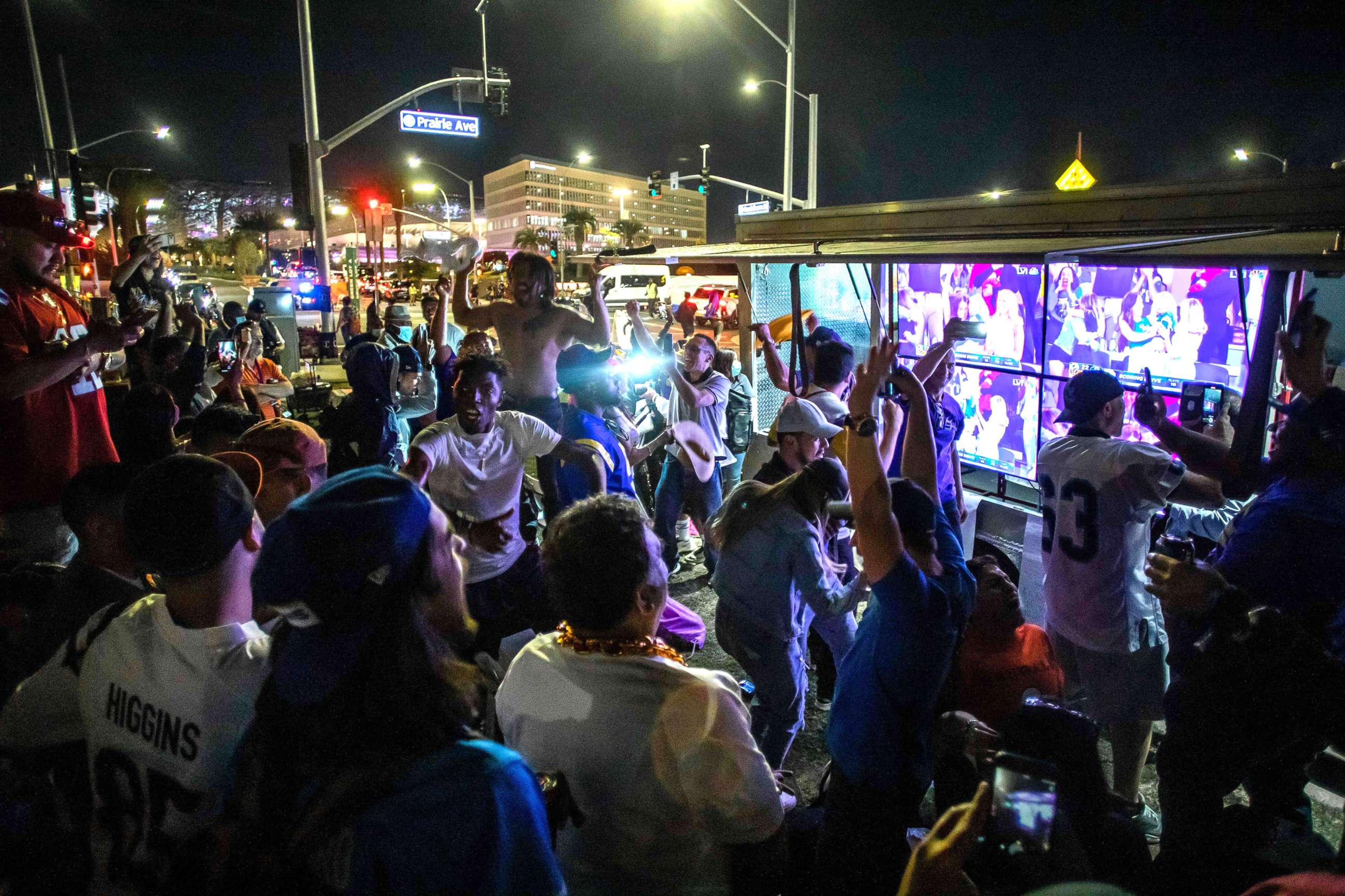 PHOTO: Fans celebrate the victory of the Los Angeles Rams over the Cincinnati Bengals while they watch the game on a screen in a street outside the SoFi Stadium during the final match of the Super Bowl LVI in Inglewood on Feb. 13, 2022. 