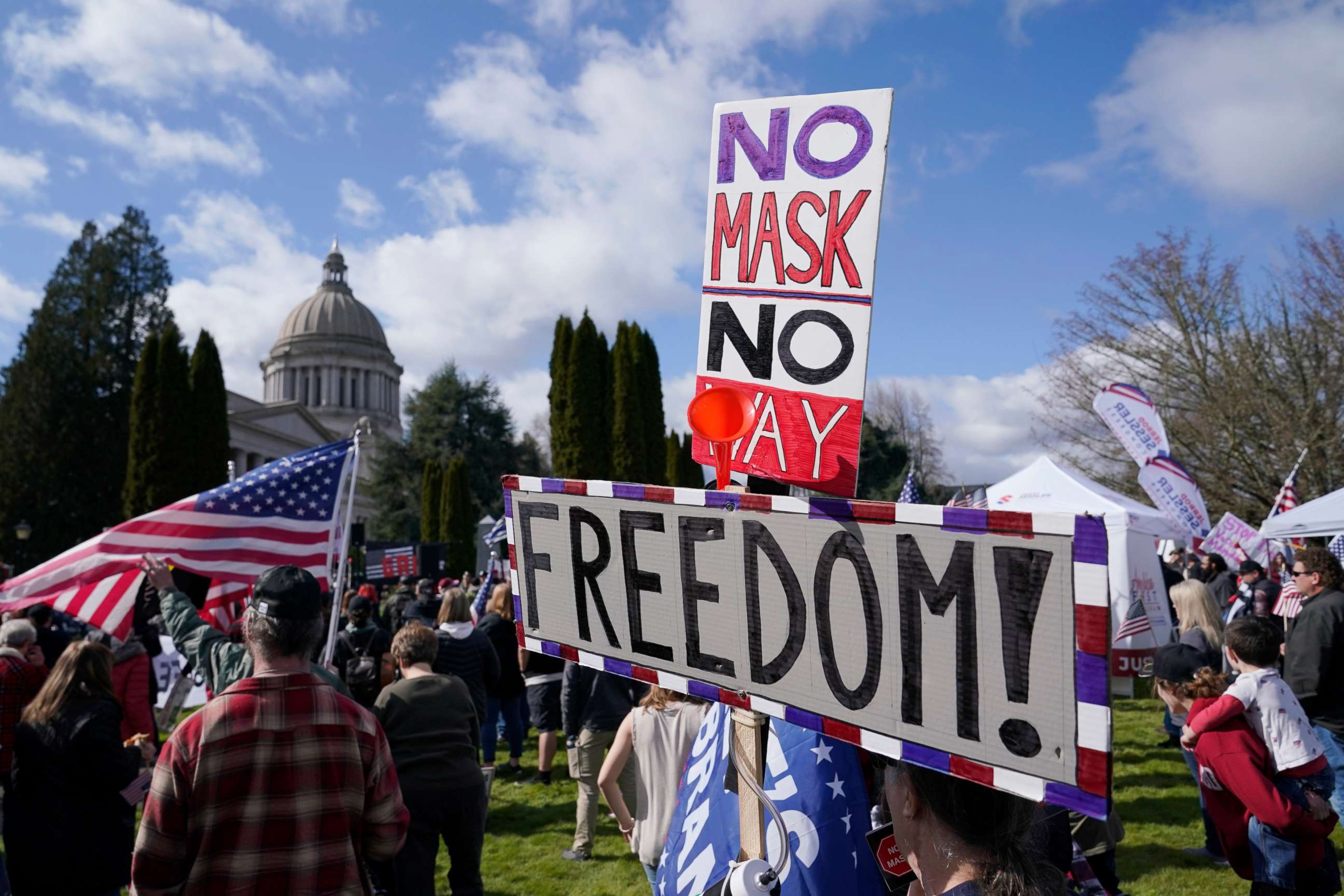 PHOTO: A person holds a sign that reads "No Mask No Way Freedom!" during a protest against COVID-19 vaccine mandates and other issues, Saturday, March 5, 2022, at the Capitol in Olympia, Wash.