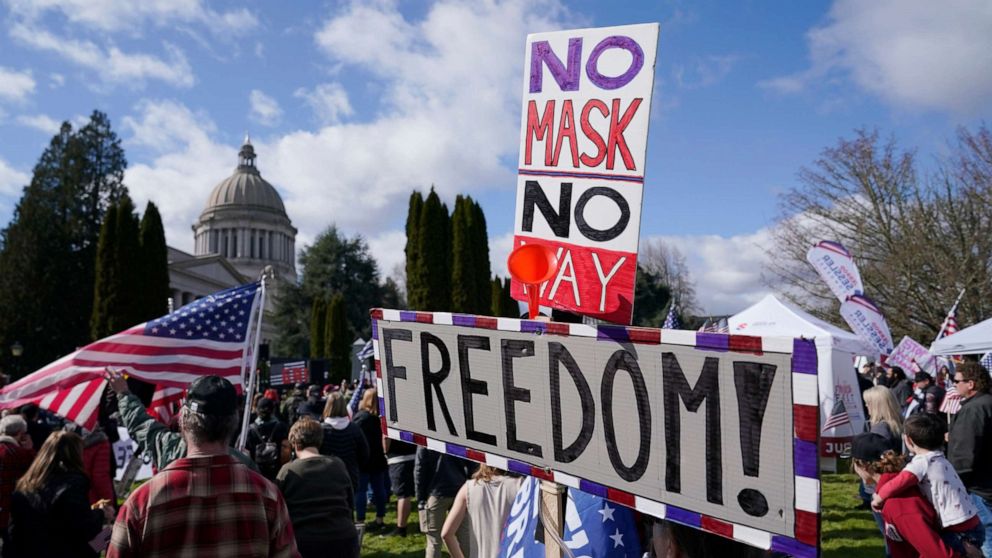 PHOTO: A person holds a sign that reads "No Mask No Way Freedom!" during a protest against COVID-19 vaccine mandates and other issues, Saturday, March 5, 2022, at the Capitol in Olympia, Wash.