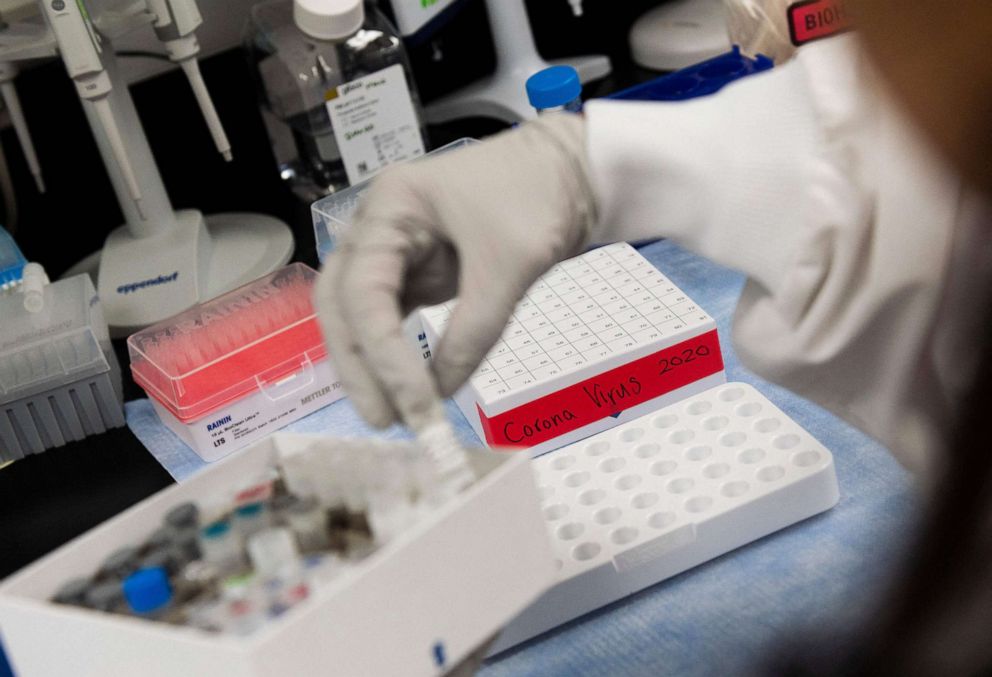 PHOTO: Dr. Nita Patel, Director of Antibody discovery and Vaccine development, lifts a vial with a potential coronavirus, COVID-19, vaccine at Novavax labs in Gaithersburg, Maryland, March 20, 2020.