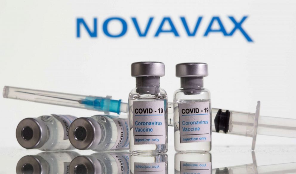 PHOTO: Vials labelled "COVID-19 Coronavirus Vaccine" and syringe are seen in front of displayed Novavax logo in this illustration taken, Feb. 9, 2021.