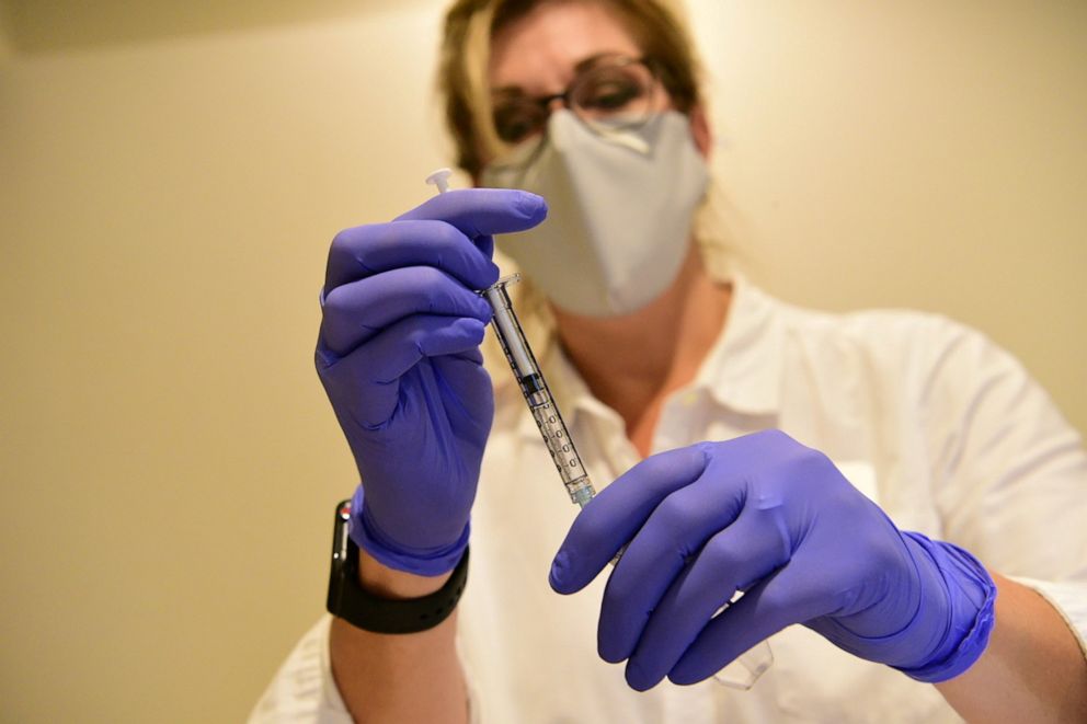 FILE PHOTO: A Johnson & Johnson worker prepares a syringe during the Phase 3 ENSEMBLE trial of its Janssen coronavirus disease (COVID-19) vaccine candidate in an undated photograph. 