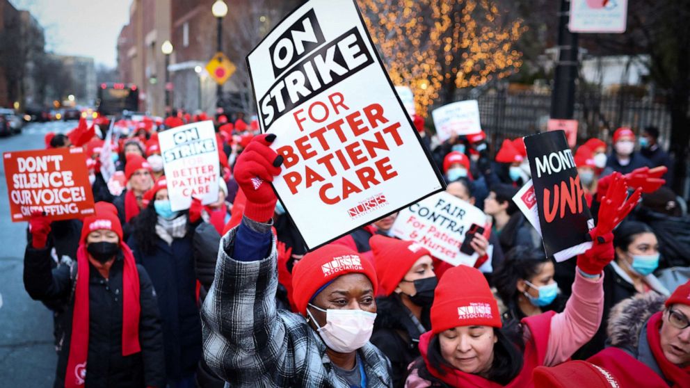 PHOTO: Striking New York State Nurses Association (NYSNA) union nurses walk along the picket line outside Montefiore Hospital on January 9, 2023 in New York.
