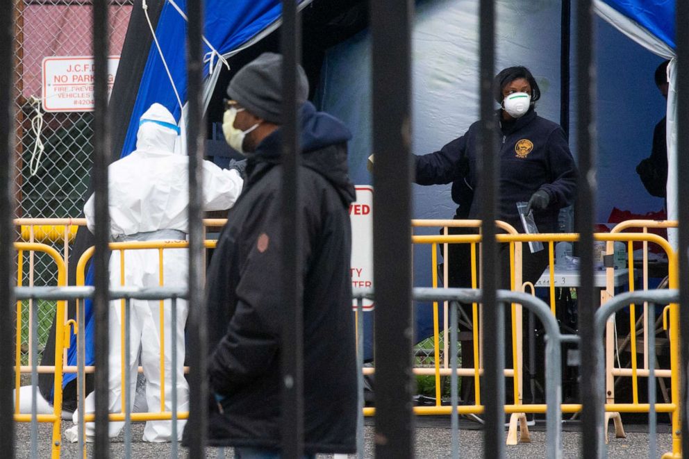 PHOTO: Medical professionals work at a coronavirus walk-up testing site at Public Safety Headquarters on April 10, 2020, in Jersey City, N.J.