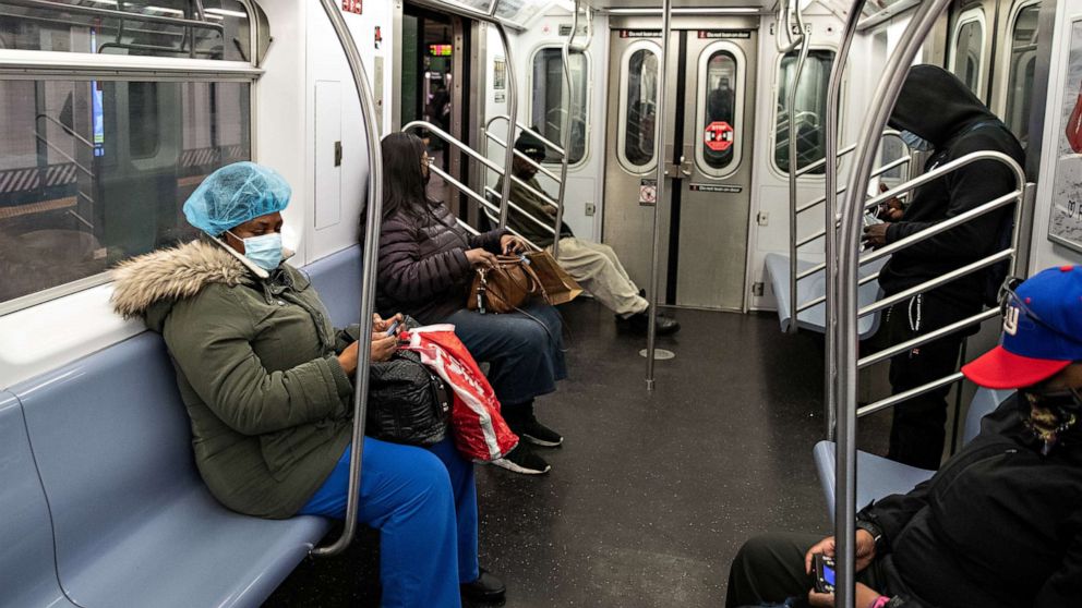PHOTO: People wearing face masks are seen in a subway car at the Times Square station during the outbreak of the coronavirus disease (COVID-19), in New York City, April 17, 2020. 
