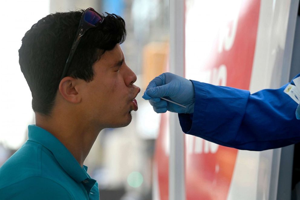 PHOTO: A medical technician administers a COVID-19 test to a man in Time Square in New York City, July 15, 2022.