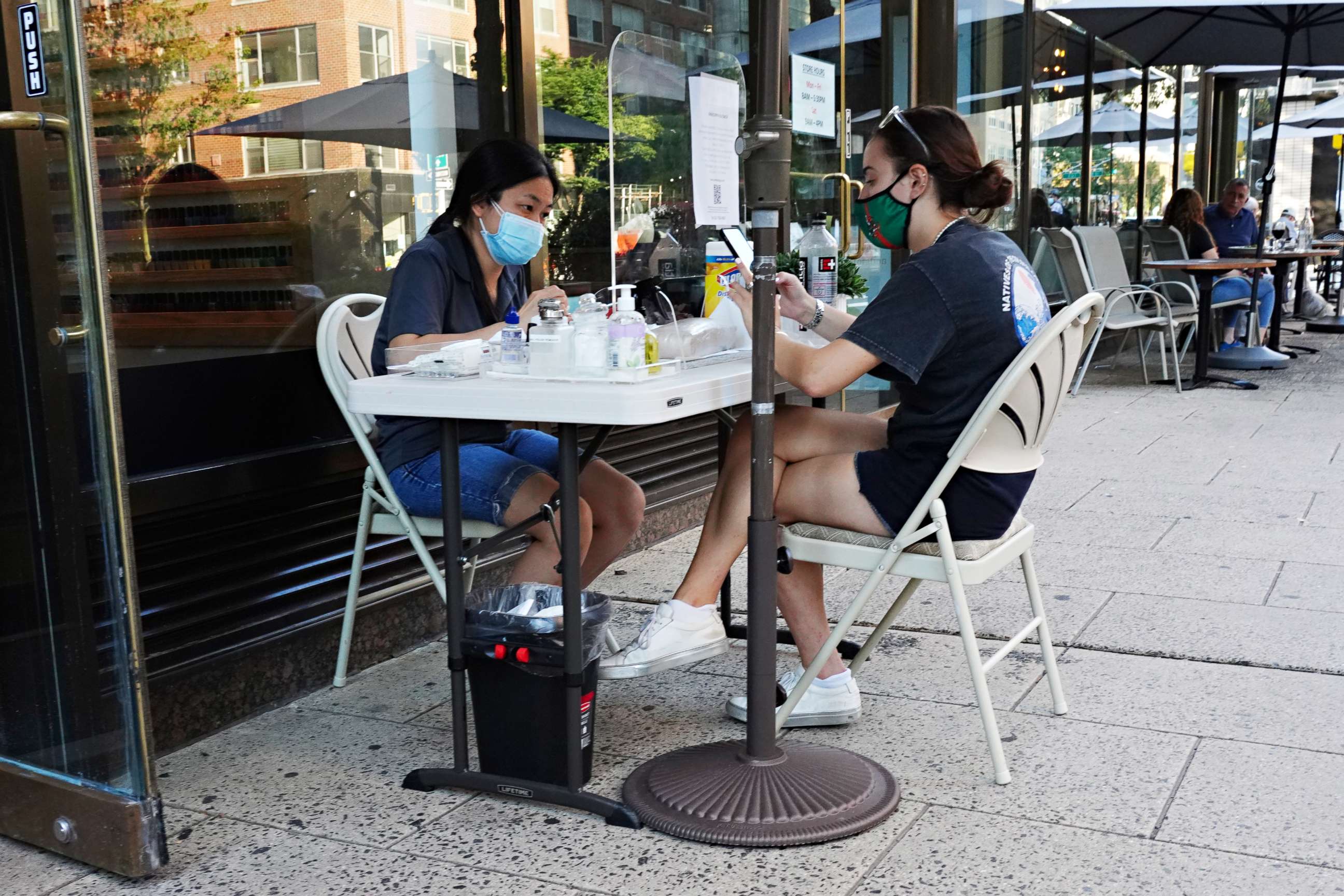 PHOTO: A woman wearing a protective mask gets a manicure at an outside station at a nail salon as the city continues Phase 4 of re-opening following restrictions imposed to slow the spread of coronavirus on August 8, 2020 in New York City. 