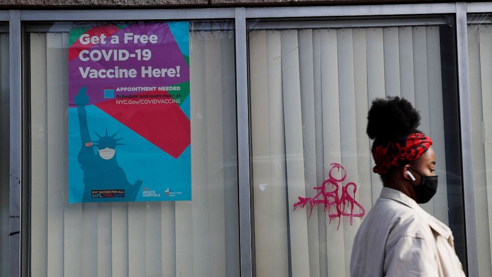 PHOTO: A woman walks by a NYC Vaccine Hub, as the coronavirus disease continues, outside the Bathgate Post Office facility in the Bronx borough of New York, Jan. 21, 2021.