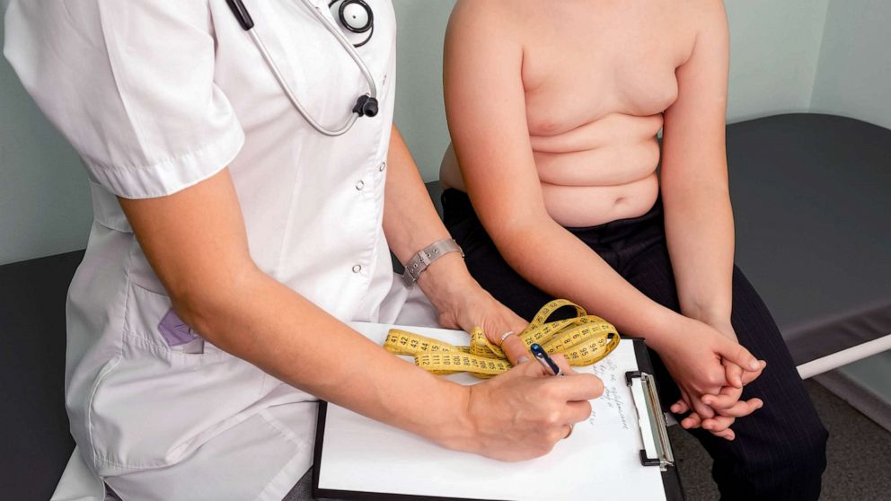 PHOTO: FILE - Doctor examining an overweight boy