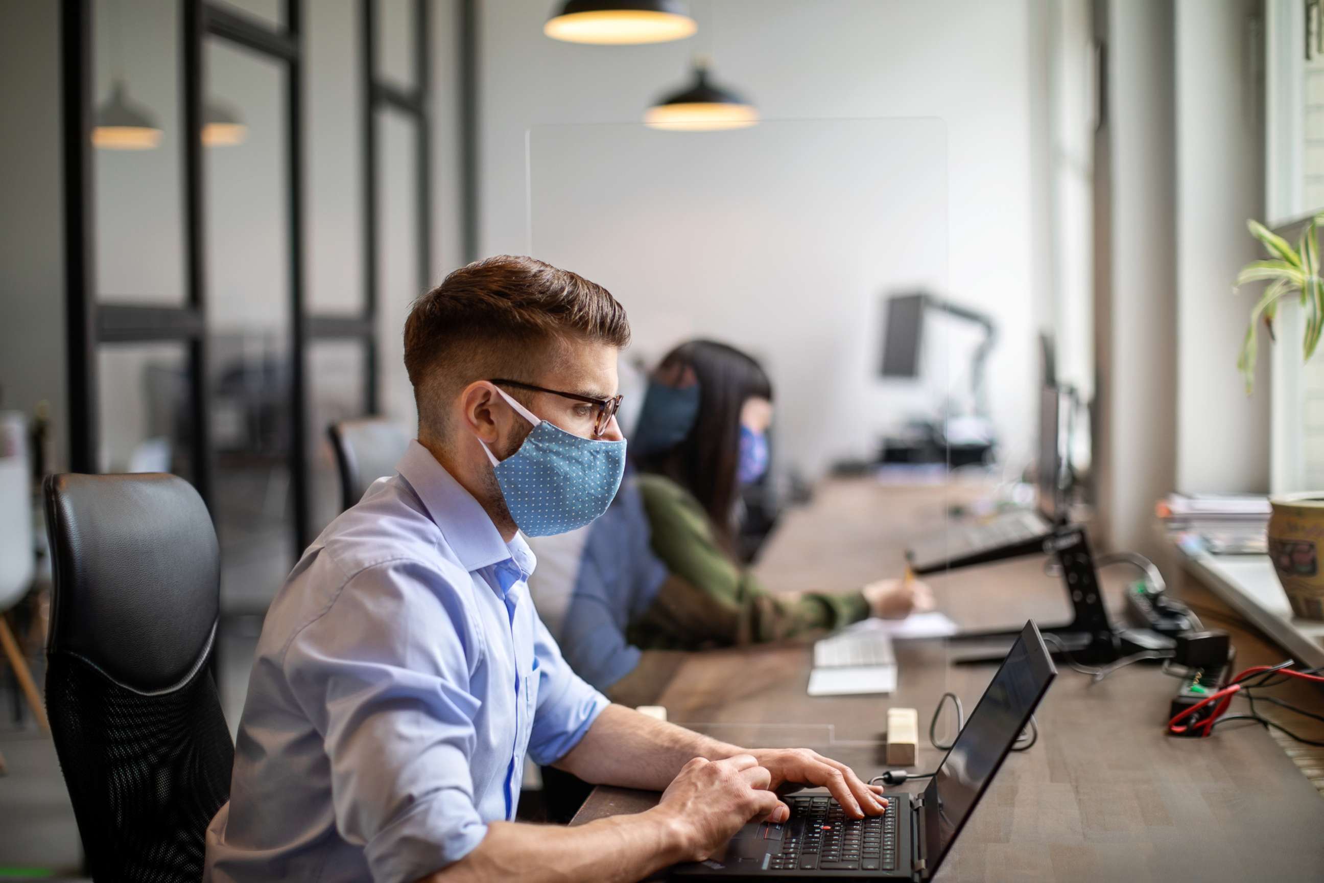 PHOTO: In this undated file photo, people wear masks while working in an office.