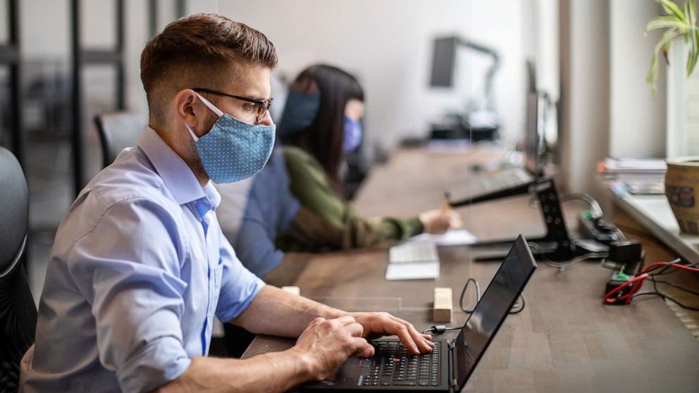 PHOTO: In this undated file photo, people wear masks while working in an office.