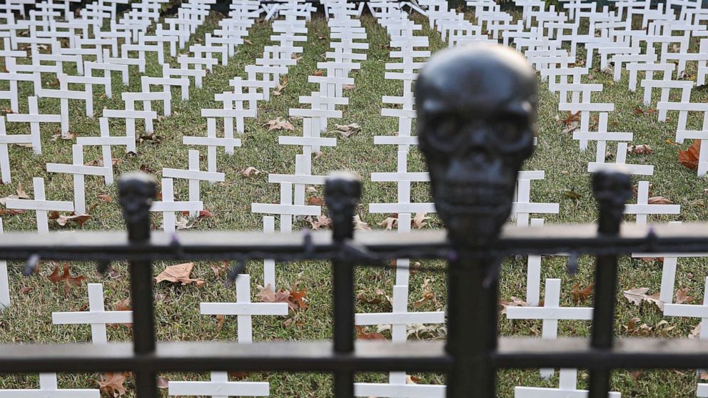 PHOTO: Toby Gregory's yard that is adorned with over 1,000 white crosses to represent Oklahoma deaths due to COVID-19, Oct. 14, 2020, in Tulsa, Okla.