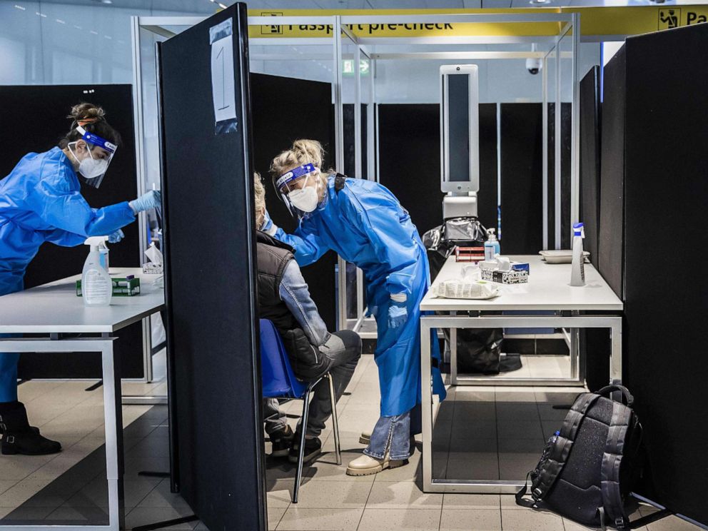 PHOTO: Travelers from South Africa are tested for the coronavirus (Covid-19) on arrival in a specially designed test street at Schiphol airport in Amsterdam, Nov. 30, 2021. 