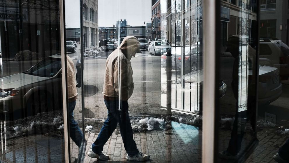 A man walks through an economically stressed section of the city on March 20, 2018 in Worcester, Mass. Like a growing number of Northeastern cities, Worcester has a chronic problem with homelessness and opioid addiction.