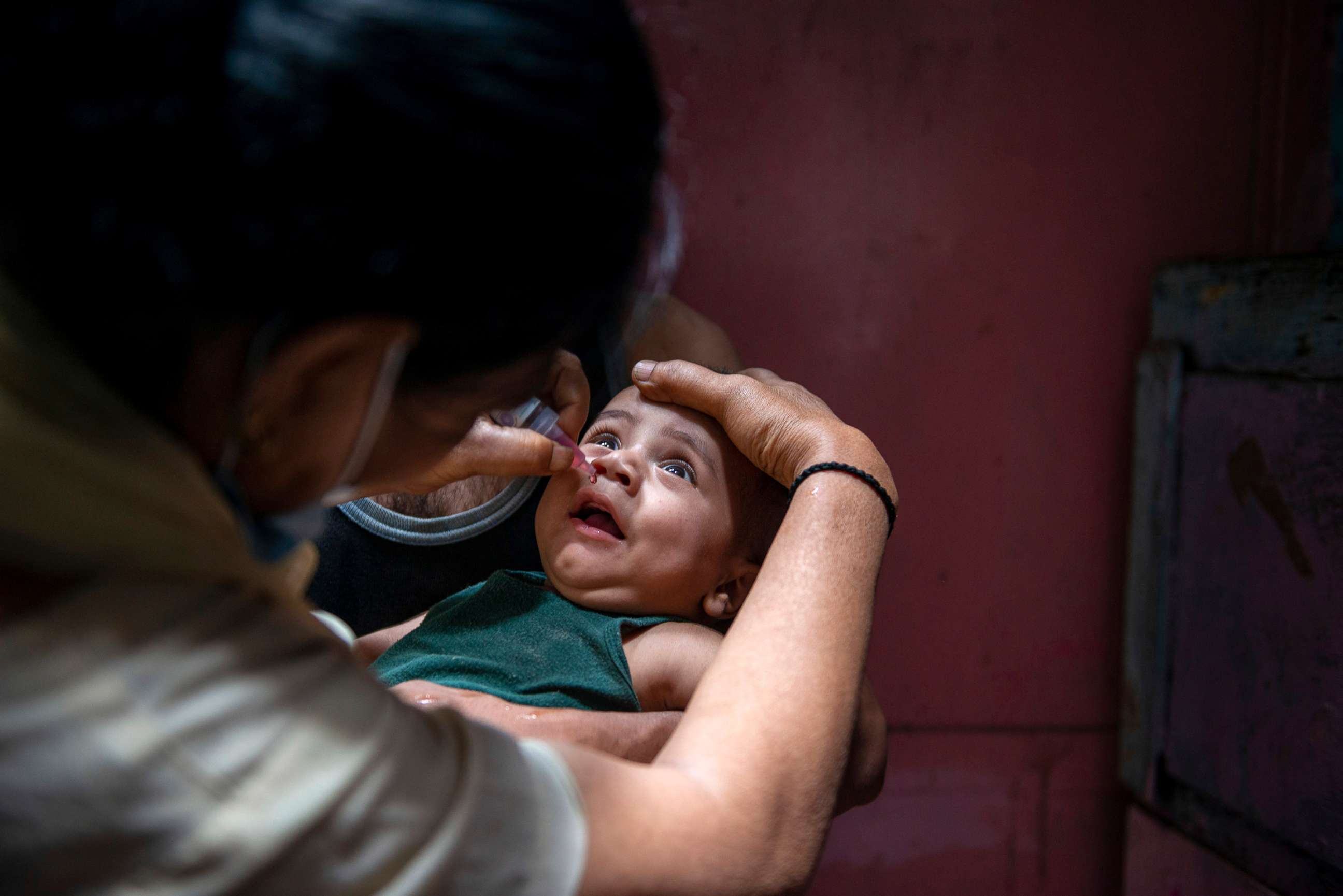 PHOTO: A health worker administers a dose of polio vaccine to a child during a national polio immunization drive in India, June 27, 2021.