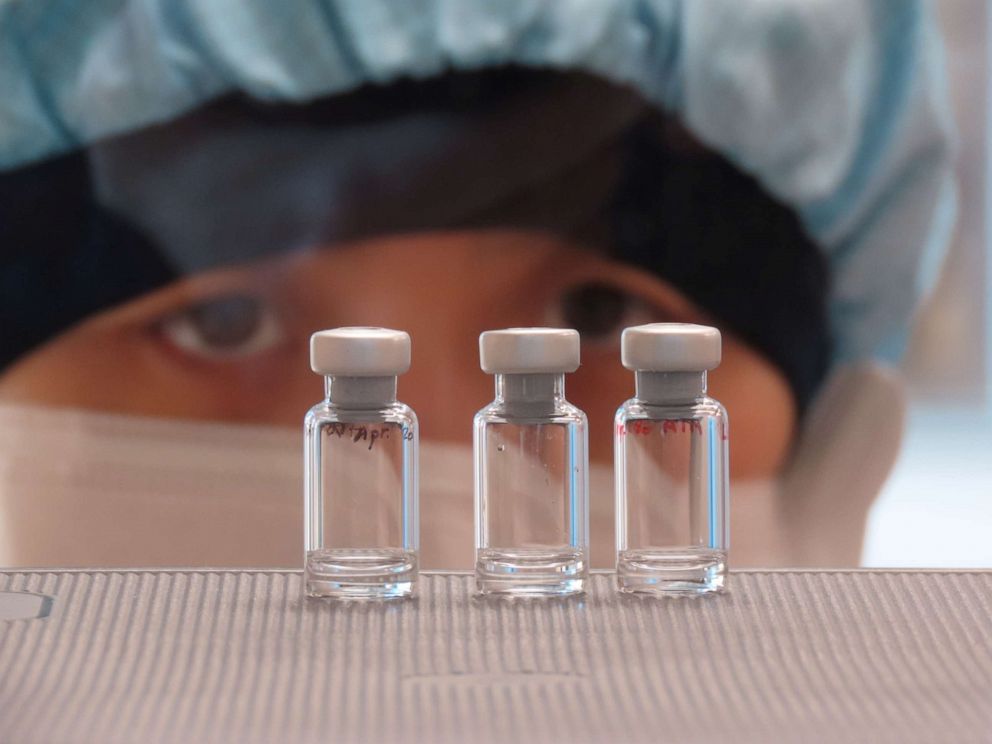 PHOTO: In this April 2, 2020, file photo, a scientist checks quality control of vaccine vials for correct volume at the Clinical Biomanufacturing Facility (CBF) in Oxford, Britain. 