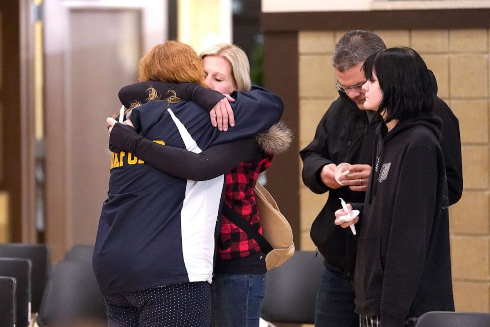 PHOTO: People attending a vigil embrace at LakePoint Community Church in Oxford, Mich.,  Nov. 30, 2021, after a student opened fire at Oxford High School, killing three students and wounding several others, including a teacher. 