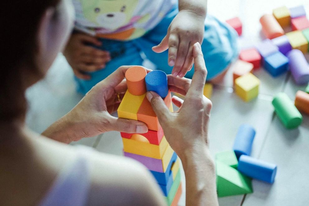 PHOTO: This stock photo depicts a mother using building blocks with her child.