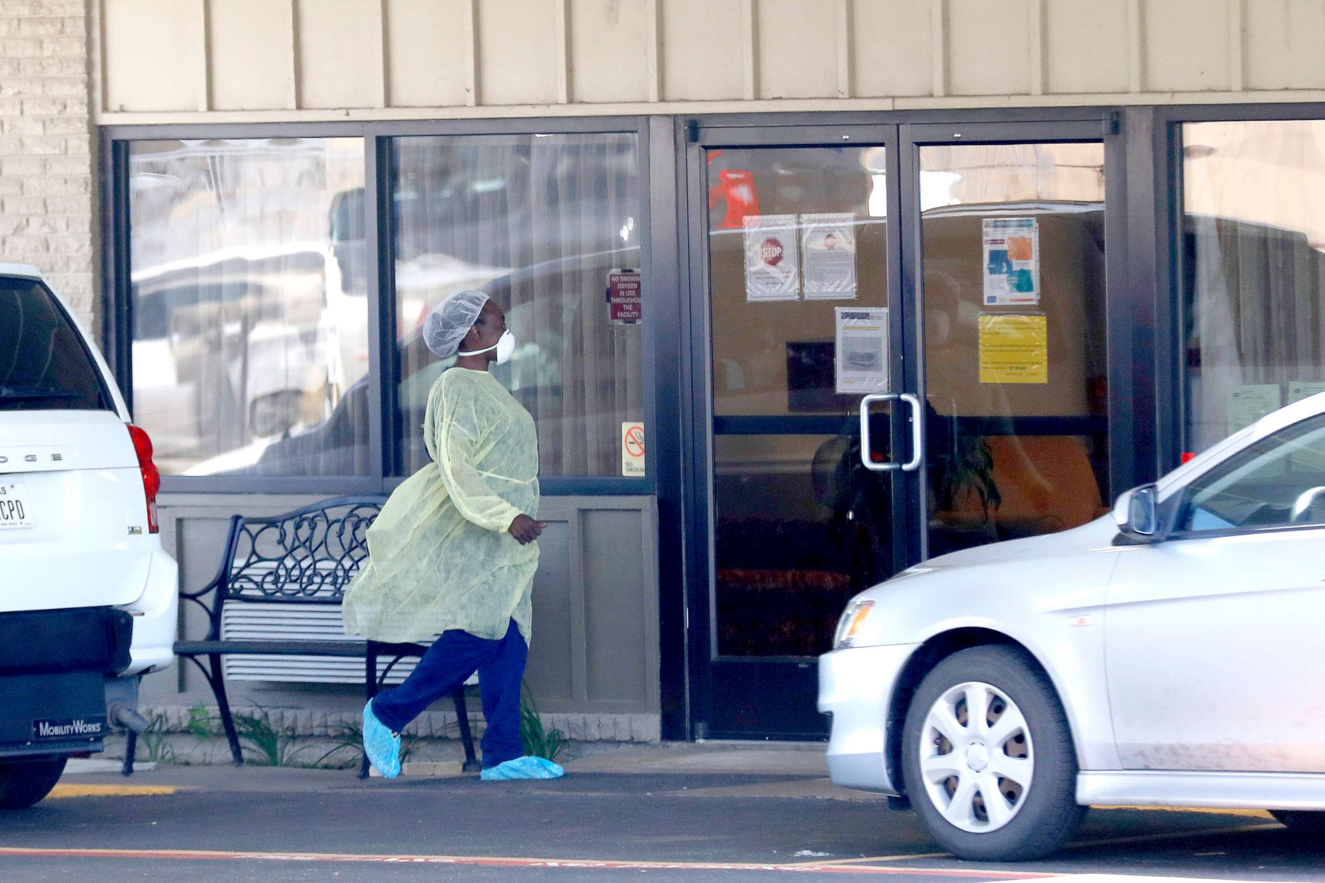 PHOTO: A medical worker wearing personal protective equipment walks outside the Paris Healthcare Center in Paris, Texas, April 29, 2020.