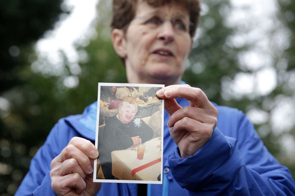 PHOTO: Pat Herrick holds a photo of her mom Elaine Herrick, 89, a resident of Life Care Center who died from COVID-19, in Kirkland, Wash., March 5, 2020.