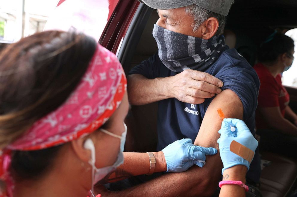 PHOTO: A man receives his first dose of the Pfizer vaccine against the coronavirus at the mass vaccination site at Ripken Baseball on May 5, 2021 in Aberdeen, Md. 