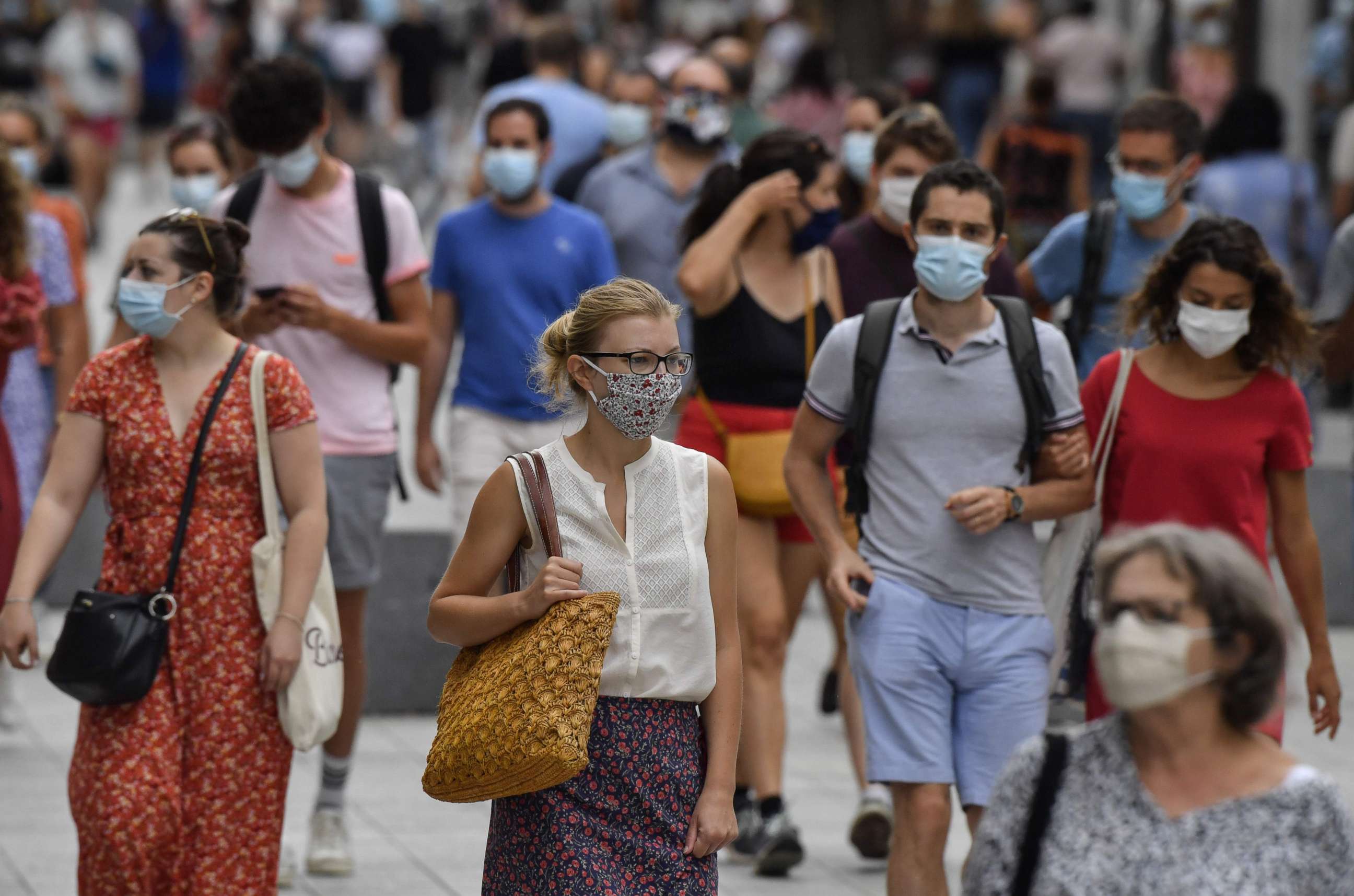 PHOTO: People wearing face masks walk on a pedestrian street in Lyon, France, on Aug. 22, 2020, on the first day of mandatory mask wearing in parts of the city center. 