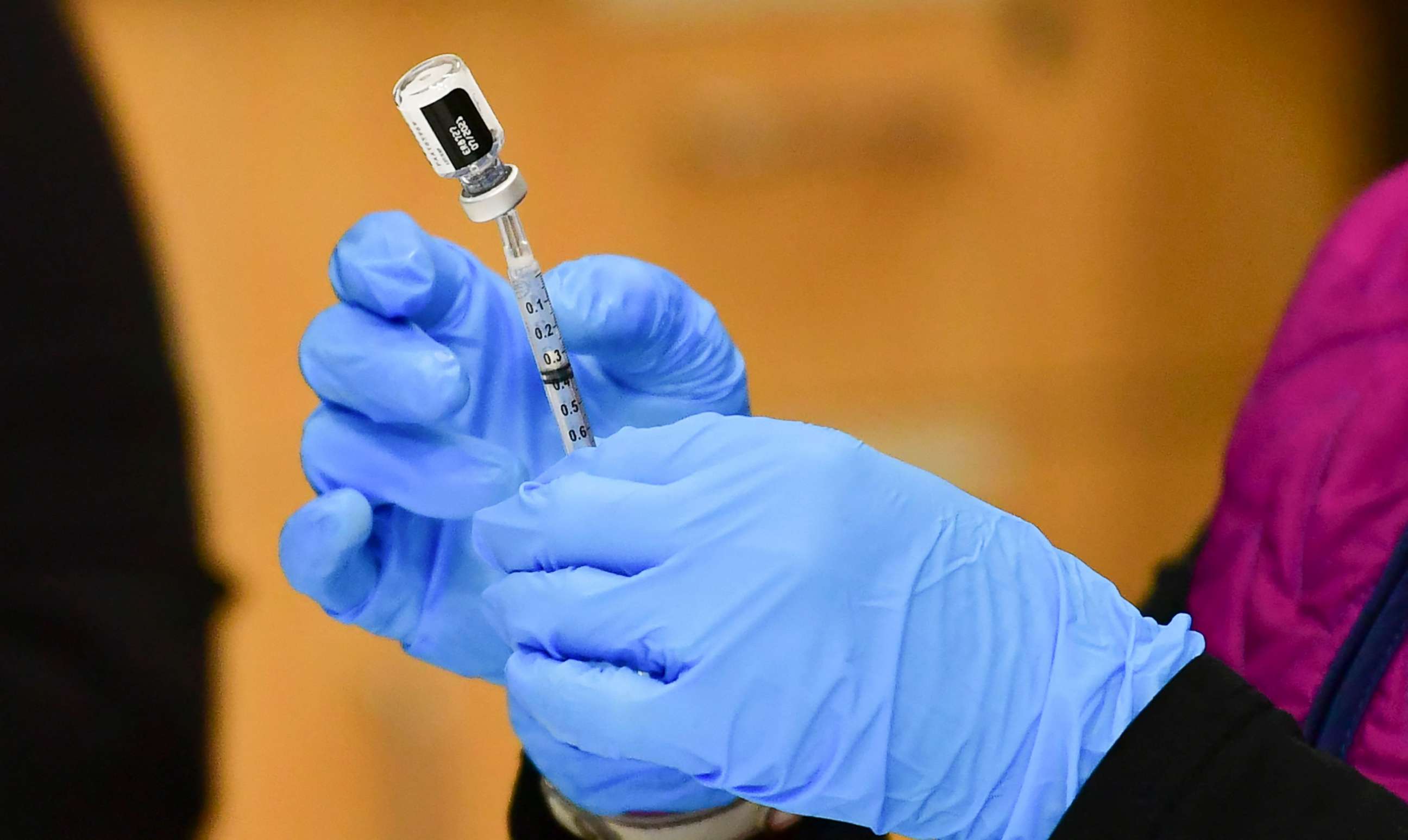 PHOTO: Registered Nurse Morgan James loads a syringe with a dose of the Pfizer Covid-19 vaccine at the Blood Bank of Alaska in Anchorage, March 19, 2021. 