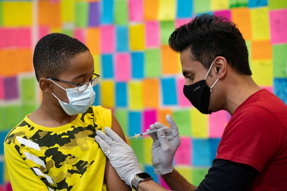 PHOTO: Dr. Mayank Amin administers a Pfizer-BioNTech COVID-19 booster vaccine to 10-year-old Ernest "EJ" Jones at Skippack Pharmacy in Schwenksville, Pa., May 19, 2022.