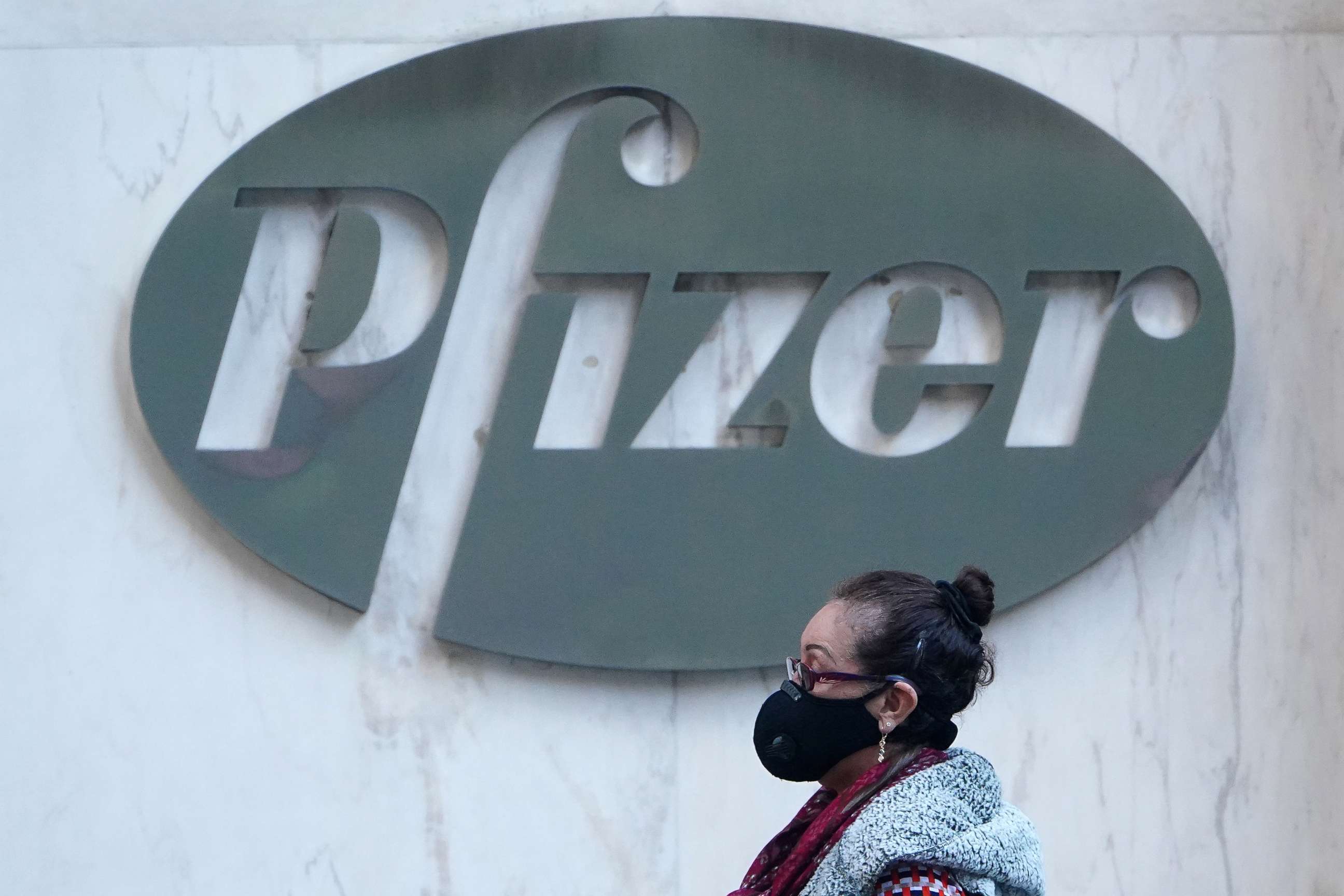 PHOTO: A person walks past the Pfizer Headquarters building in the Manhattan borough of New York City, Nov. 9, 2020. 