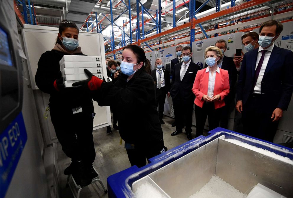 PHOTO: European Commission President Ursula von der Leyen, Pfizer CEO Albert Bourla and Belgium's Prime Minister Alexander De Croo watch workers moving boxes of vaccines from a freezer at the Pfizer factory in Puurs, Belgium, April 23, 2021.  