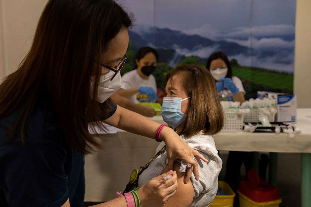 PHOTO: A hospital worker is inoculated with a booster dose of Pfizer-BioNTech COVID-19 vaccine against the coronavirus in Valenzuela Medical Center, Valenzuela City, Philippines, April 25, 2022. 