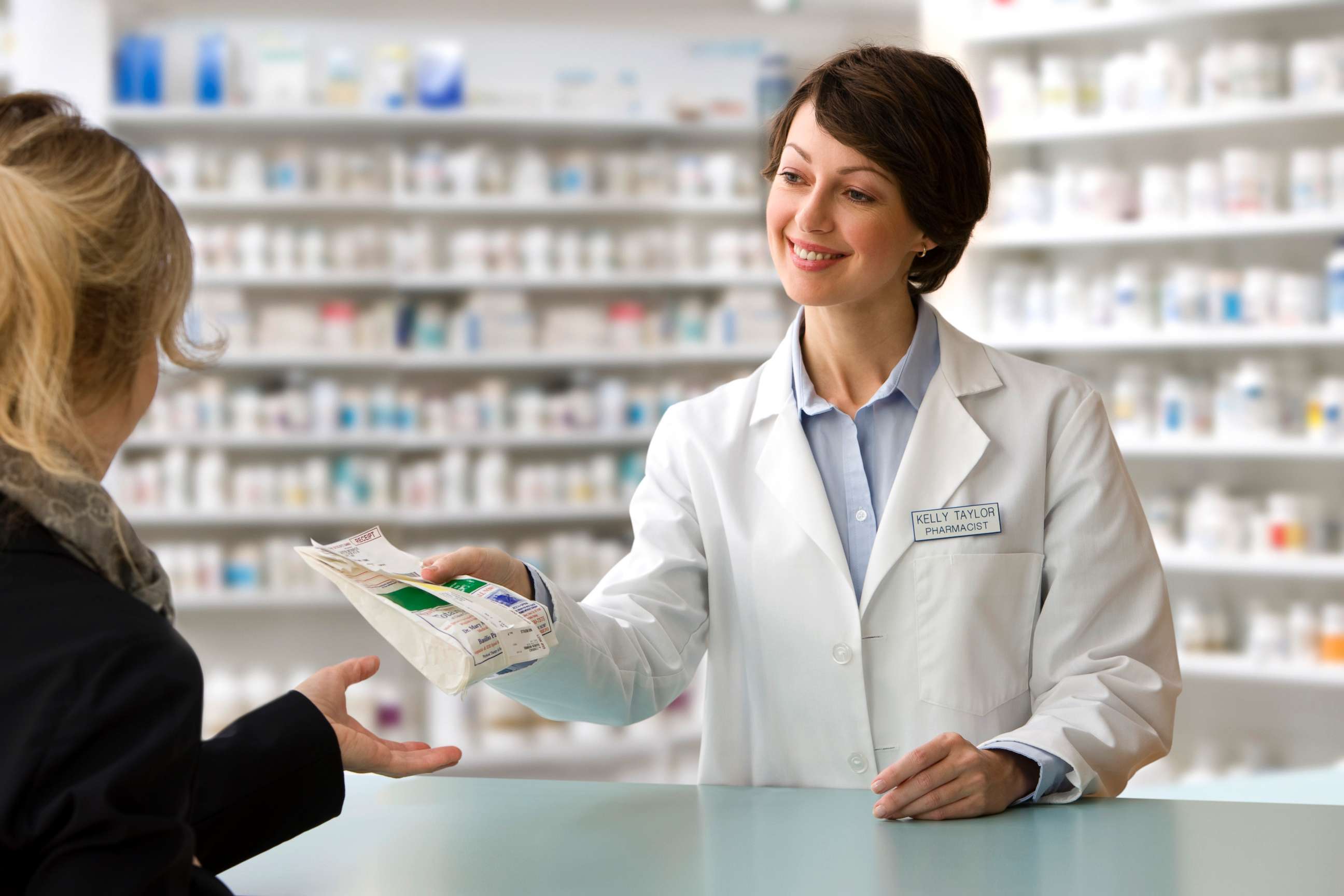 PHOTO: A pharmacist delivers a customer's prescription in this stock photo.