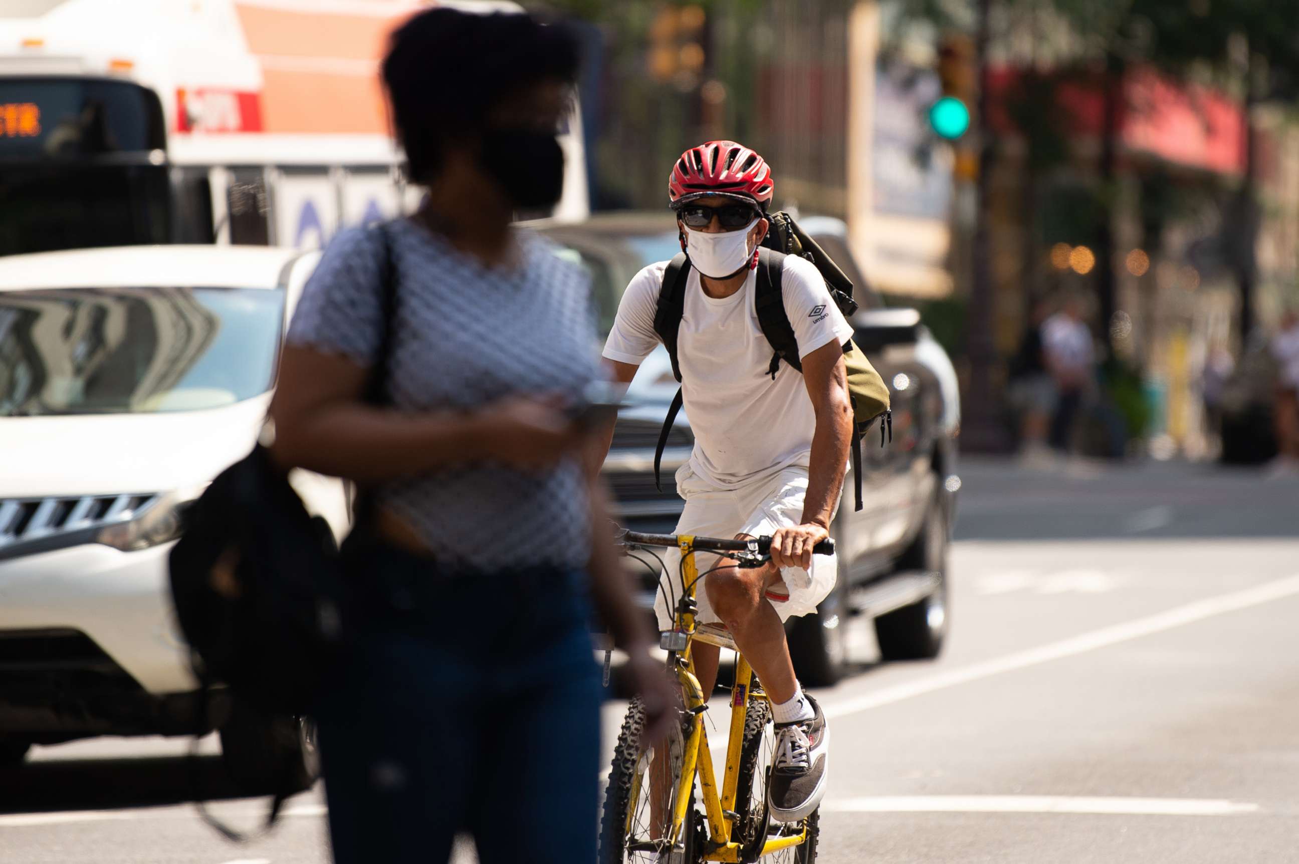 PHOTO: A cyclist wears a protective mask while riding in downtown Philadelphia, Aug. 12, 2021. 
