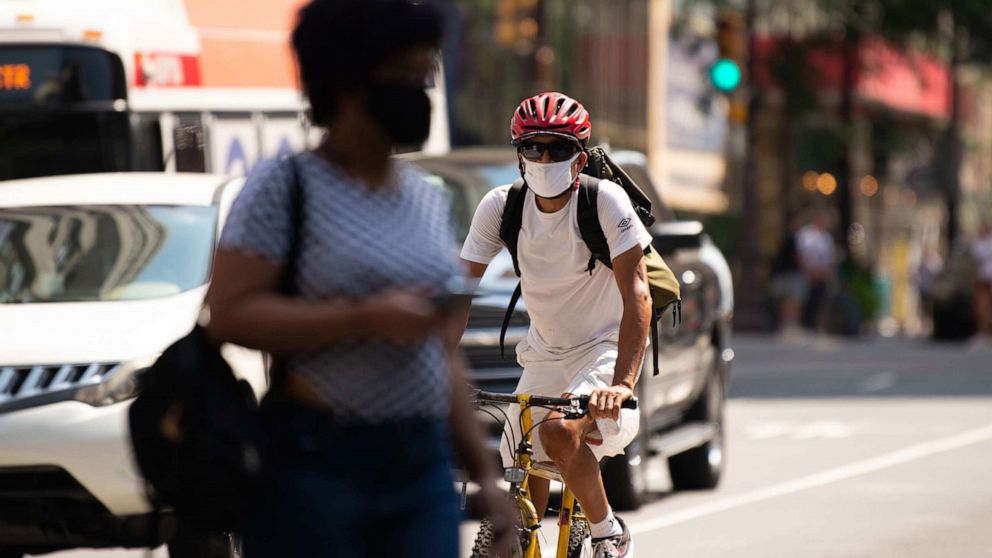PHOTO: A cyclist wears a protective mask while riding in downtown Philadelphia, Aug. 12, 2021.