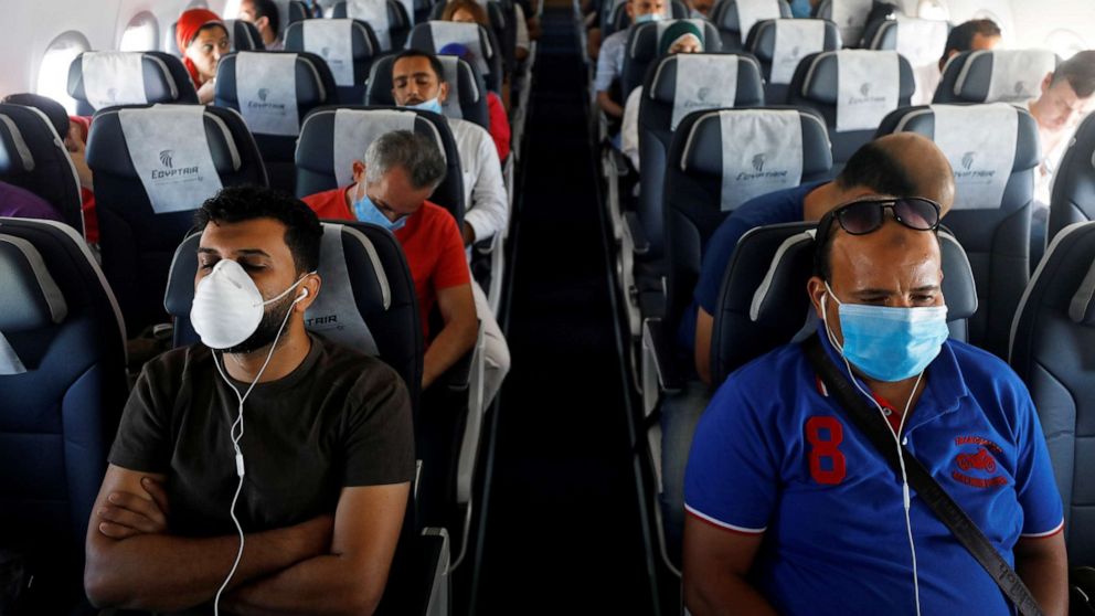 PHOTO: Passengers wearing protective face masks sit on a plane at Sharm el-Sheikh International Airport, following the outbreak of the coronavirus disease (COVID-19), in Sharm el-Sheikh, Egypt, June 20, 2020. 
