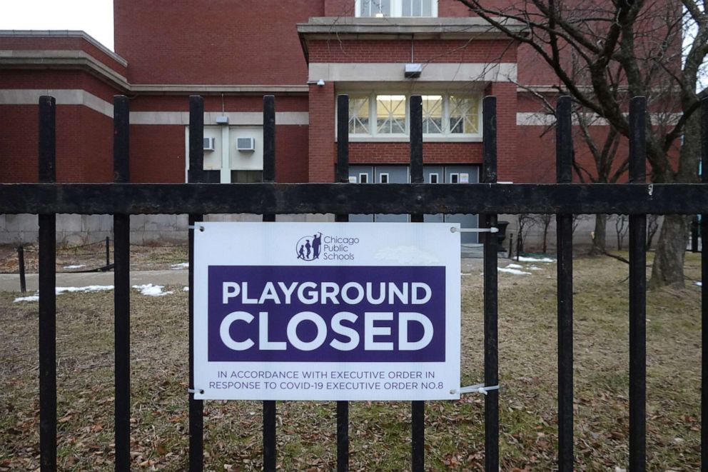 PHOTO: A sign outside of Columbus Elementary School lets visitors know that the playground has been closed, Jan. 25, 2021, in Chicago.