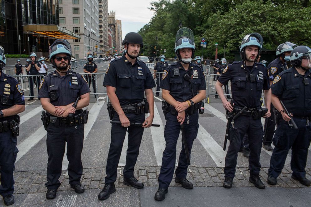 PHOTO: Police officers guard the Trump International Hotel as a large demonstration approaches on June 3, 2020 in Columbus Circle, New York City.