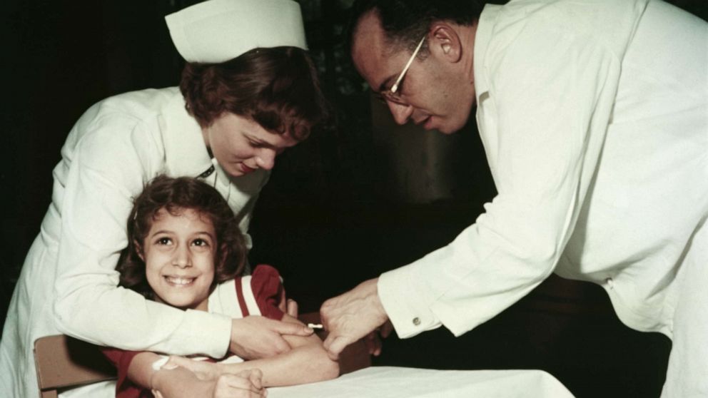 PHOTO: Dr. Jonas Salk and a nurse administer a polio vaccine to Pauline Antloger at Sunnyside School in Pittsburgh, Penn., in 1955.