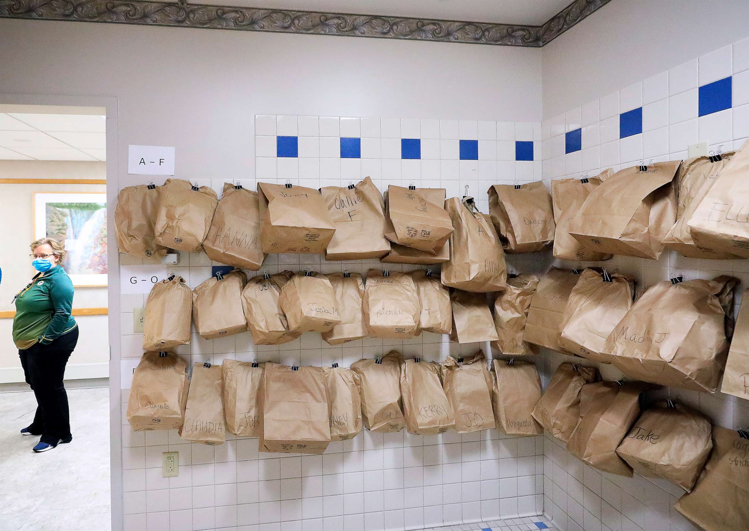 PHOTO: Bags of personal protective equipment for staff attending to patients in a COVID-19 treatment unit at UW Health in Madison, Wis. hang on a wall, Nov. 5, 2020.