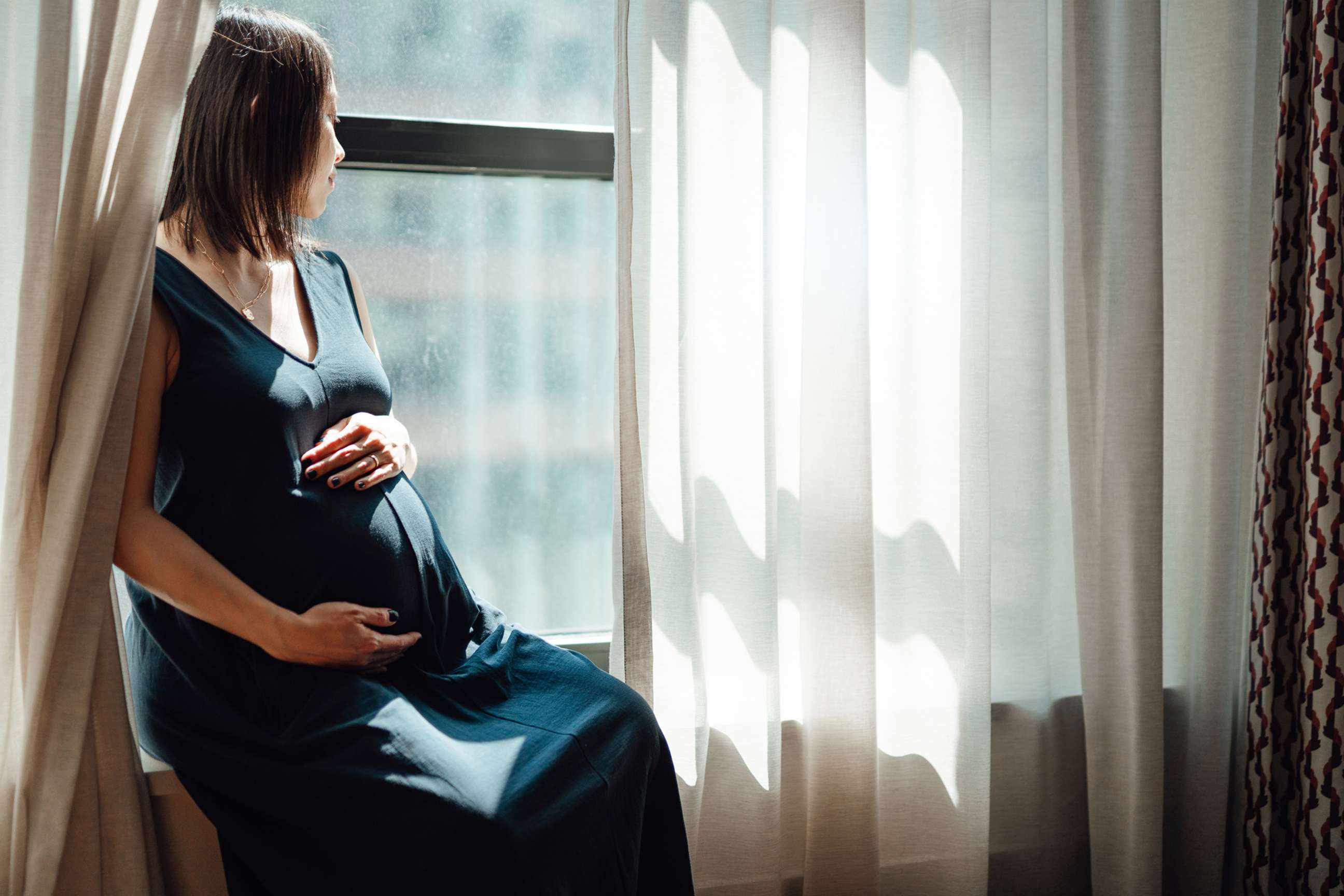 PHOTO: A pregnant woman sits by a window in an undated stock image.
