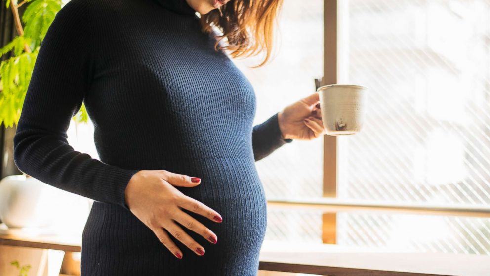 PHOTO: In this undated stock photo, a pregnant woman stands by a window.