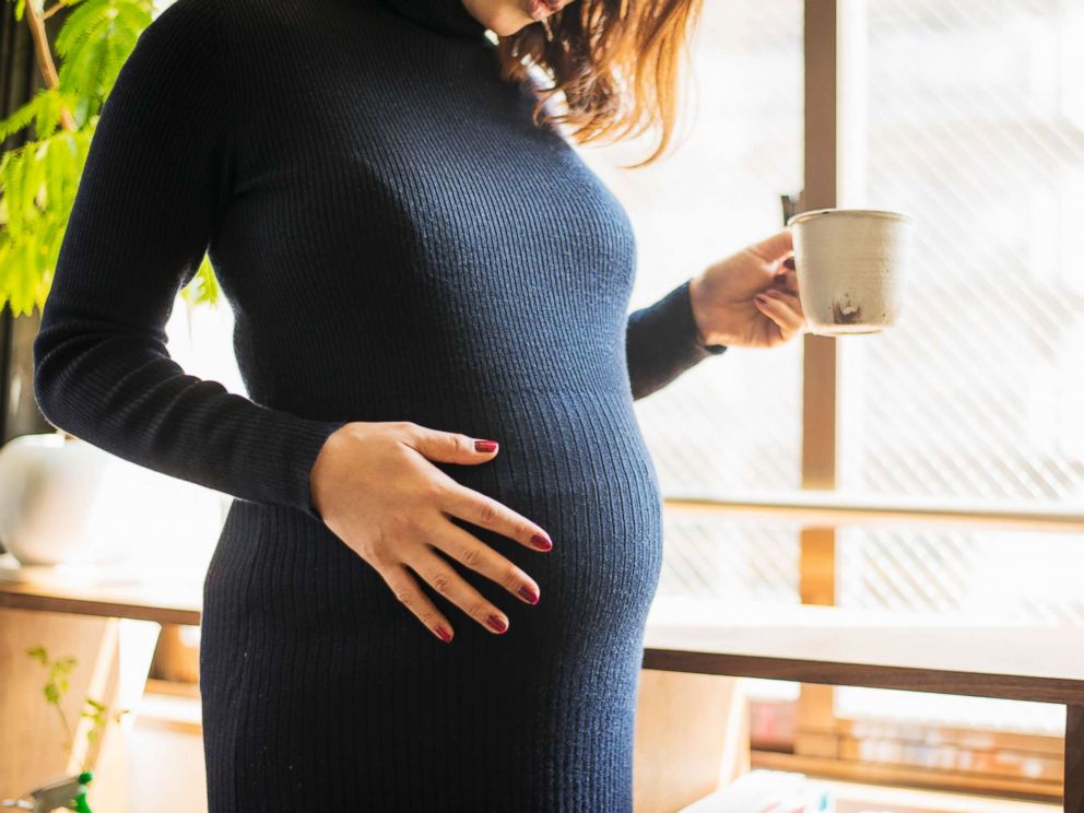 PHOTO: In this undated stock photo, a pregnant woman stands by a window.