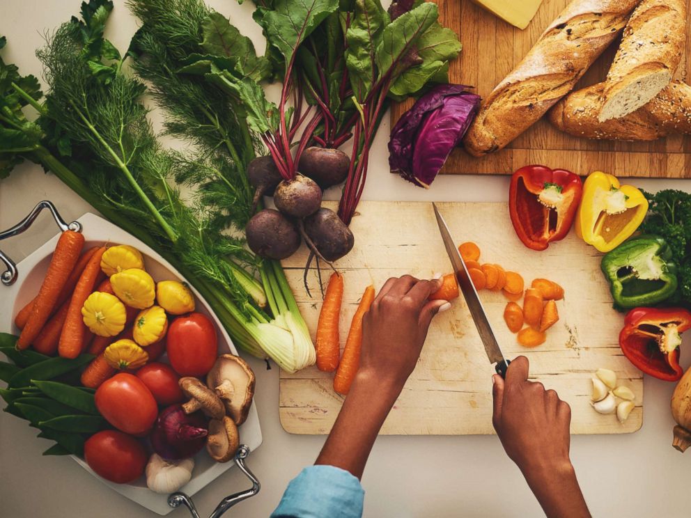 PHOTO: A person chops vegetables on a cutting board in the kitchen at home in an undated stock photo.