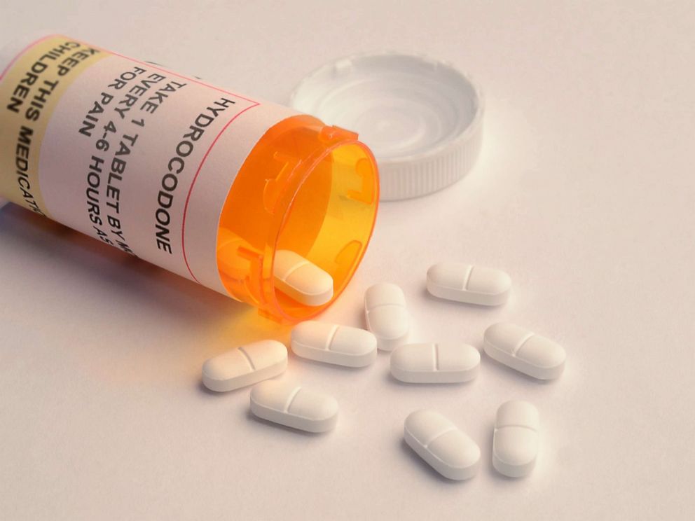 PHOTO: Close-up of an opened prescription bottle, labelled as containing the opioid hydrocodone, as a number of its pills lie on a white surface, March 14, 2017. 