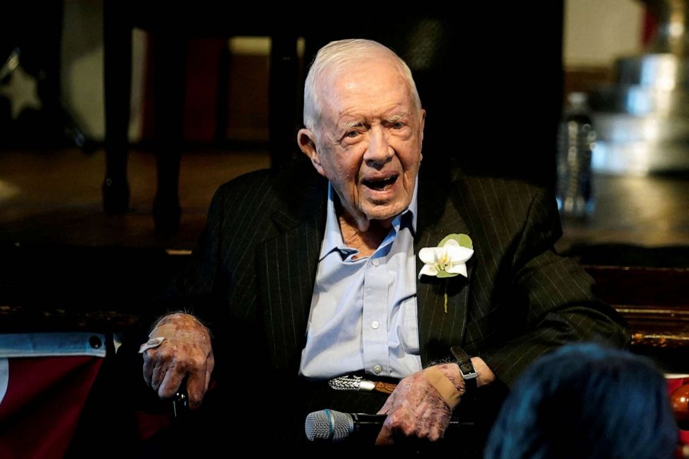 PHOTO: FILE - Former U.S. President Jimmy Carter reacts as his wife Rosalynn Carter speaks during a reception to celebrate their 75th wedding anniversary in Plains, Georgia, July 10, 2021.