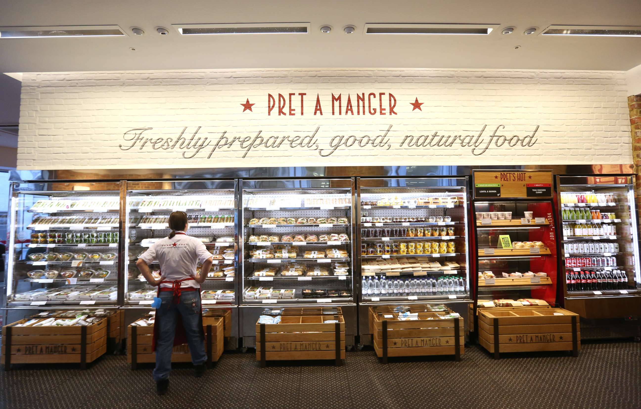 PHOTO: An employee checks the stock levels of a chilled display of sandwiches and salads inside a Pret A Manger in London, April 21, 2015.