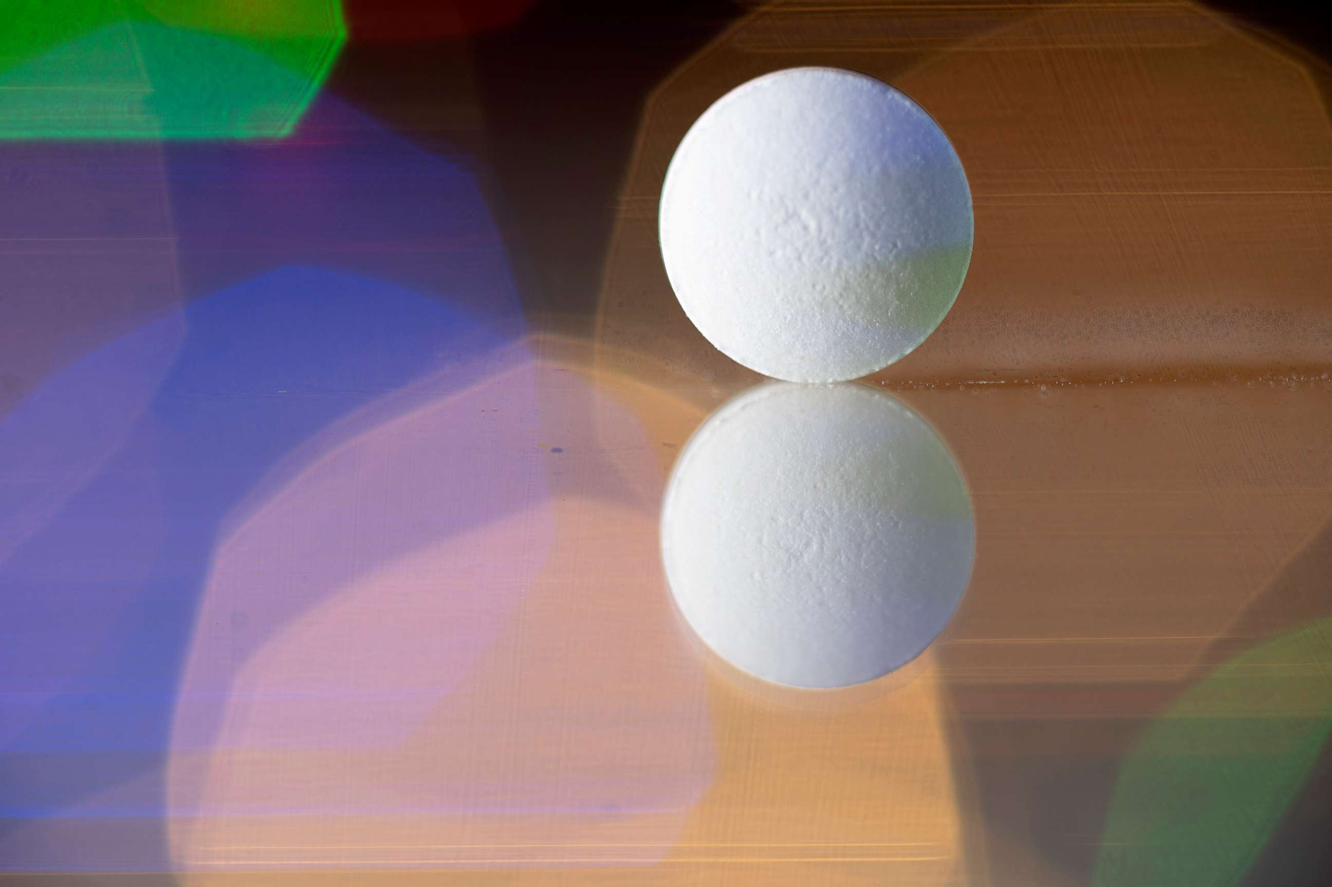 PHOTO: A pill stands on a reflective surface illuminated by multi-colored lights in an undated stock image.