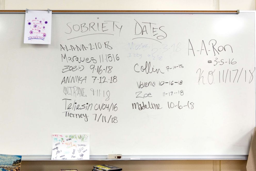 PHOTO: Students’ sobriety dates and motivational quotes are written on whiteboards in the school lounge.