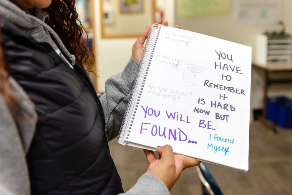 PHOTO: Student Annika Laband holds her notebook, in which she writes about her feelings about sobriety.