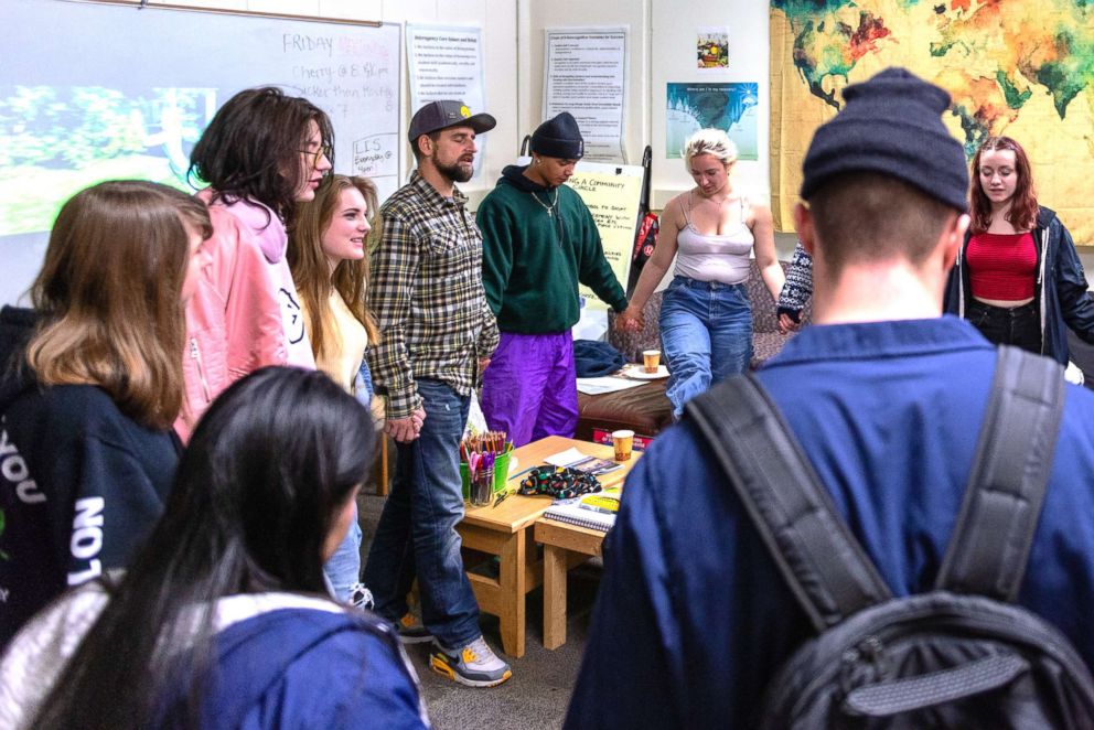 PHOTO: Students at Interagency at Queen Anne gather around the school lounge before school ends. Students meet regularly with a counselor and participate in daily group support meetings designed like Alcoholics Anonymous.